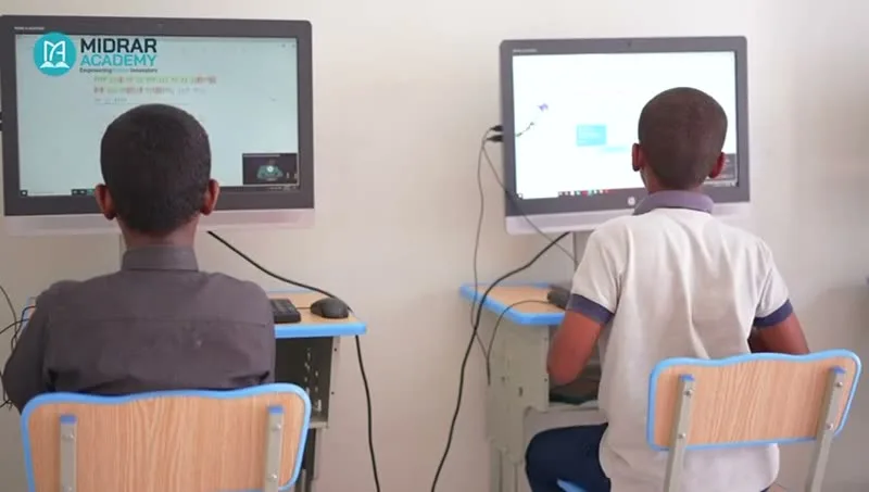 Boys at computer terminals