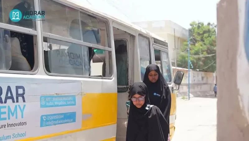 Students by the school bus